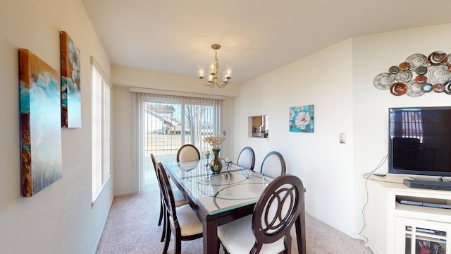 carpeted dining space featuring a chandelier