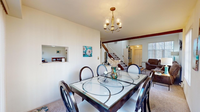 dining area featuring an inviting chandelier and carpet flooring