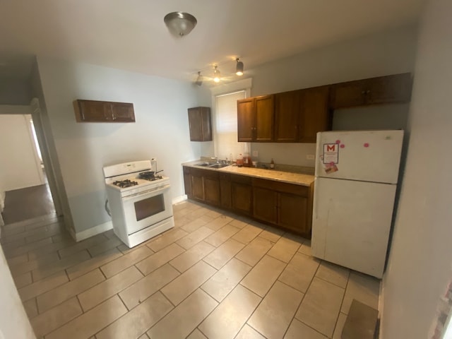 kitchen with sink and white appliances