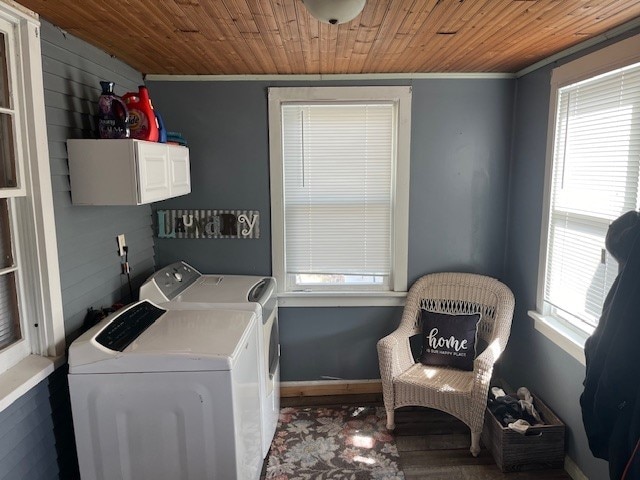 clothes washing area with cabinets, crown molding, washer and dryer, and wooden ceiling