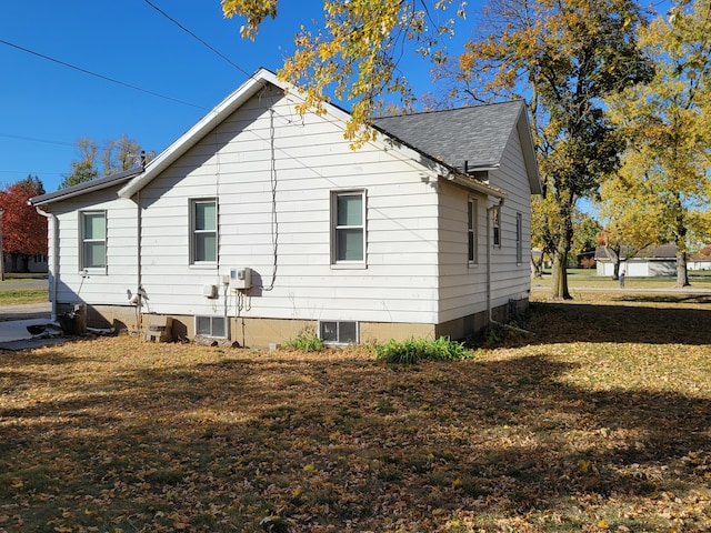 view of side of home featuring a lawn