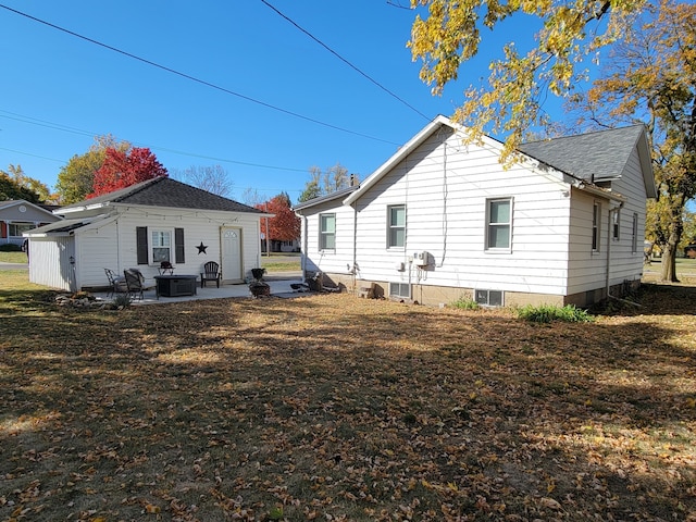 rear view of property with a yard and a patio