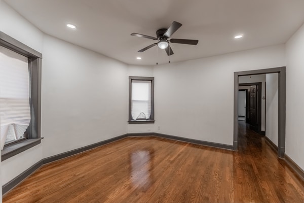 spare room with ceiling fan and dark hardwood / wood-style flooring