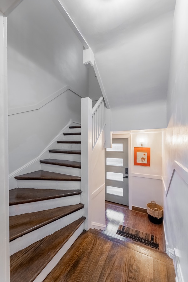 stairs featuring wood-type flooring