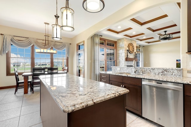 kitchen featuring dishwasher, a center island, dark brown cabinets, and pendant lighting