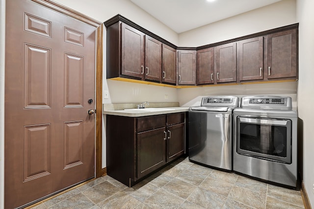 laundry area with sink, independent washer and dryer, and cabinets