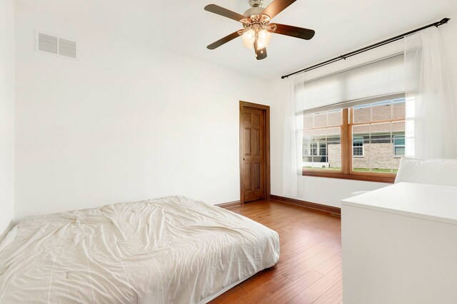 bedroom with ceiling fan and wood-type flooring