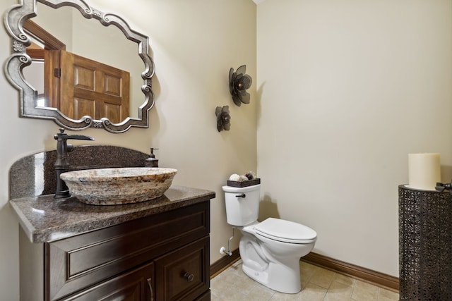 bathroom with vanity, toilet, and tile patterned flooring