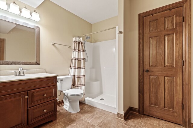 bathroom featuring vanity, a shower with curtain, and toilet