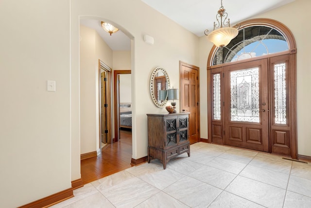 foyer entrance with light tile patterned floors