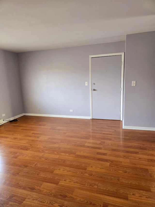 unfurnished room featuring hardwood / wood-style flooring