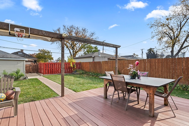 wooden terrace featuring a lawn