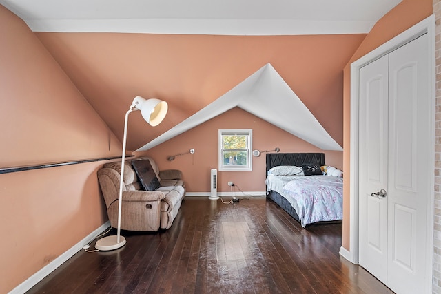 bedroom with vaulted ceiling and hardwood / wood-style floors