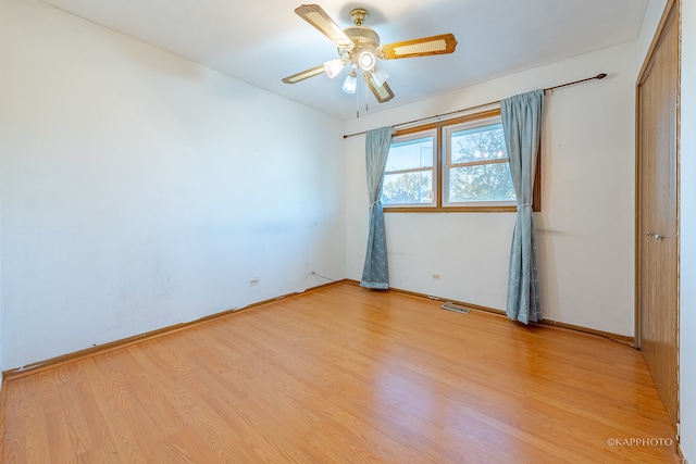 spare room with light hardwood / wood-style flooring and ceiling fan