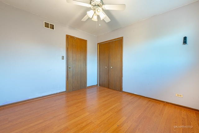 empty room featuring light wood-type flooring and ceiling fan