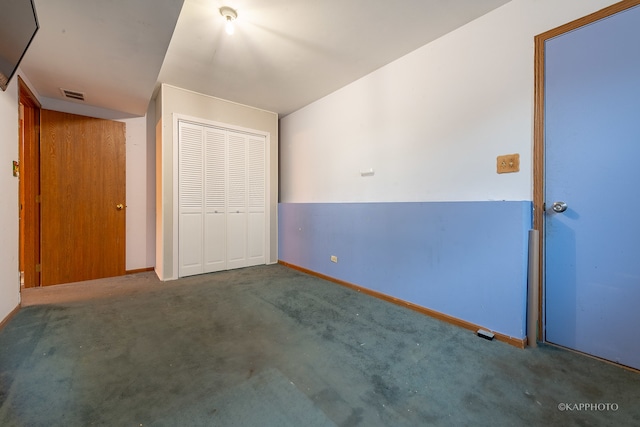 unfurnished bedroom with a closet and carpet