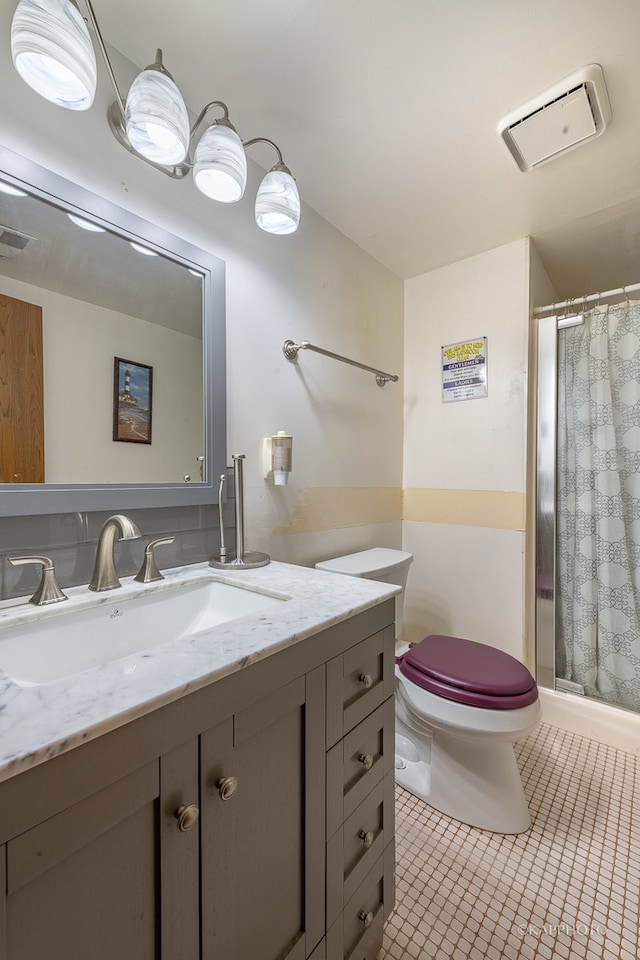 bathroom with vanity, curtained shower, toilet, and tile patterned flooring