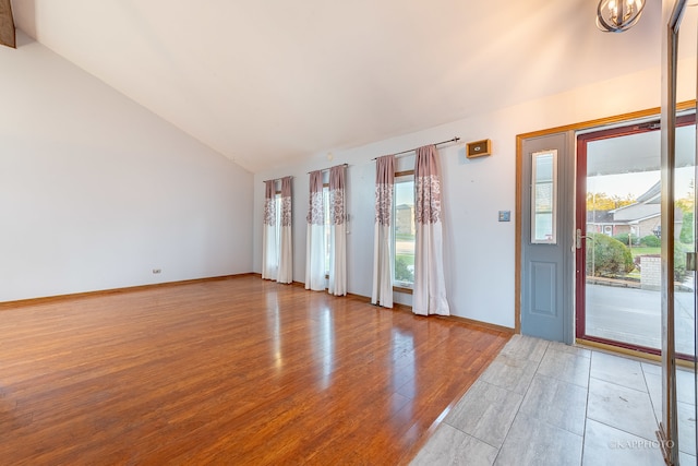 interior space with vaulted ceiling and light hardwood / wood-style flooring