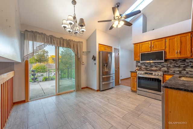 kitchen featuring ceiling fan with notable chandelier, backsplash, hanging light fixtures, stainless steel appliances, and light hardwood / wood-style flooring