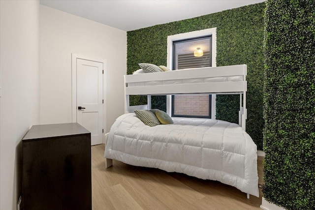 bedroom featuring baseboards and light wood-type flooring