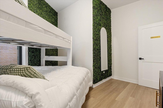 bedroom featuring light wood-style floors and baseboards