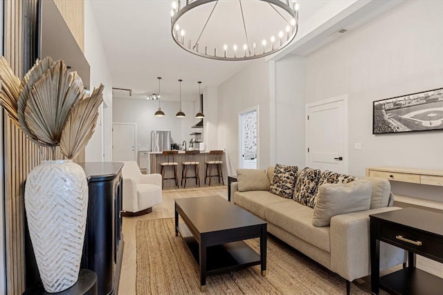 dining space featuring baseboards, visible vents, light wood finished floors, and plenty of natural light