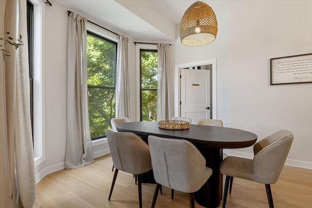dining area with wood finished floors, visible vents, baseboards, and an inviting chandelier