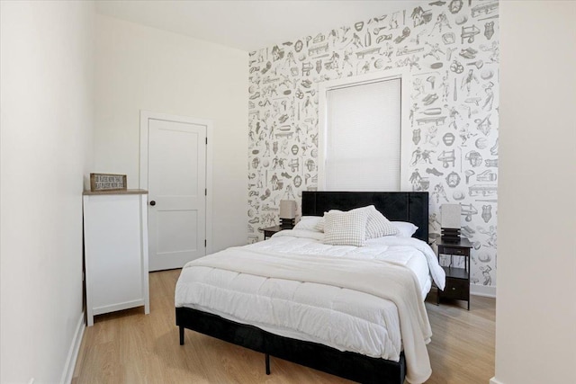 bedroom featuring light wood-style flooring and baseboards