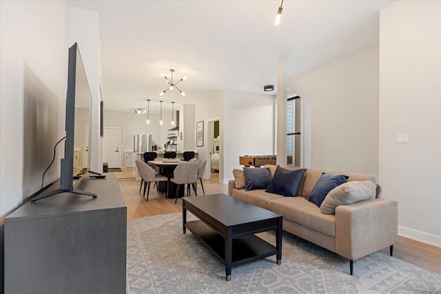 dining room featuring light wood-type flooring and baseboards