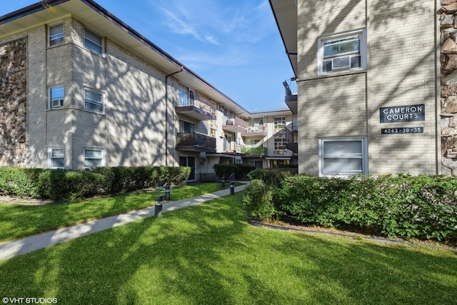 exterior space featuring a lawn and a balcony