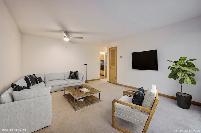 carpeted living room with ceiling fan