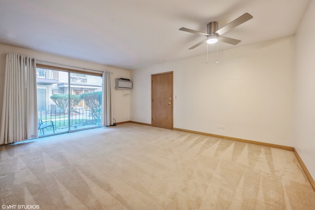 spare room with ceiling fan, light carpet, and an AC wall unit