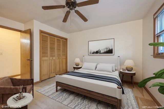 carpeted bedroom featuring ceiling fan and a closet