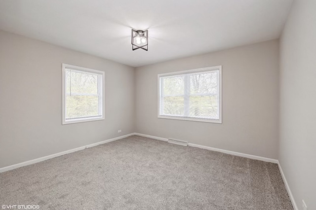 unfurnished room featuring carpet and a wealth of natural light