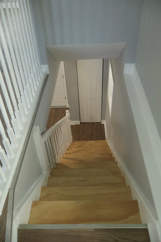 stairs featuring hardwood / wood-style flooring