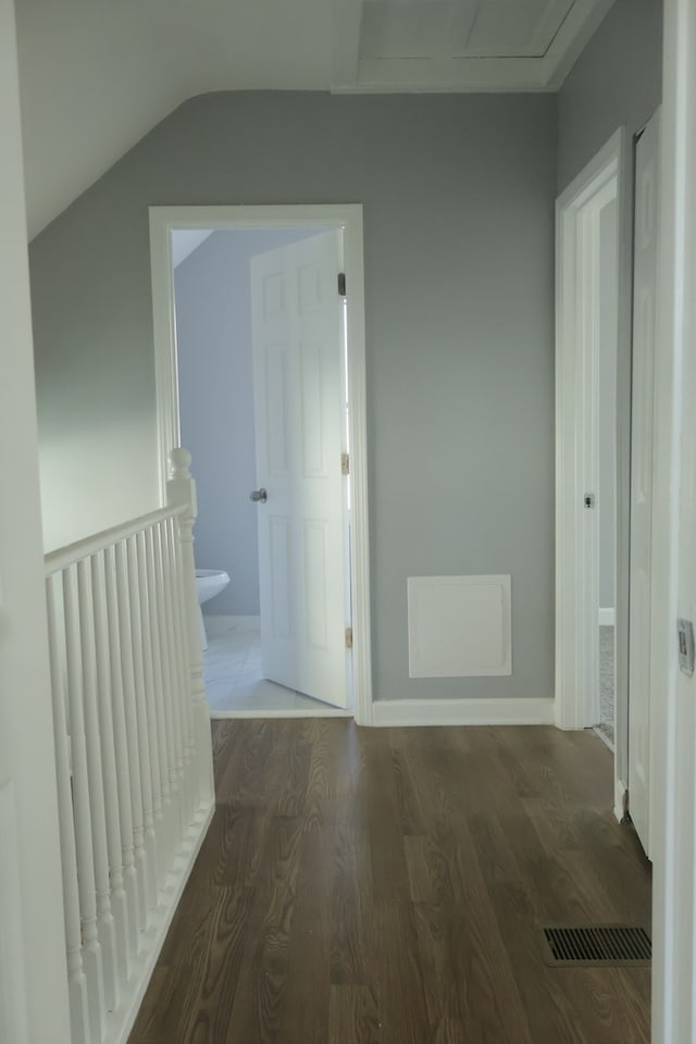 hall with dark hardwood / wood-style flooring and vaulted ceiling