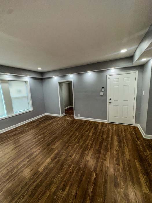 basement with dark wood-type flooring