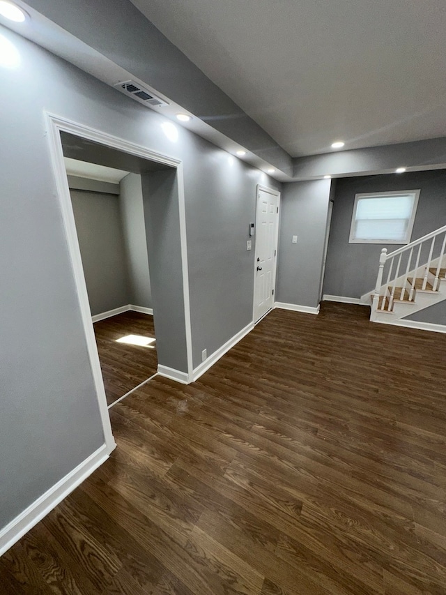 basement featuring dark hardwood / wood-style flooring