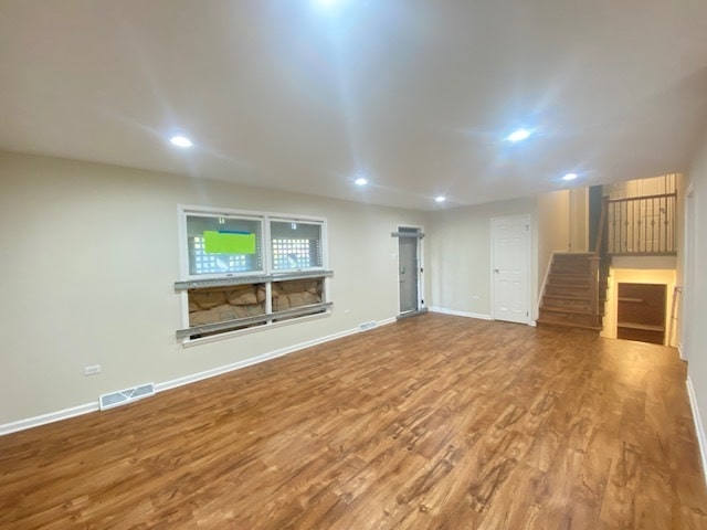 unfurnished living room featuring hardwood / wood-style floors