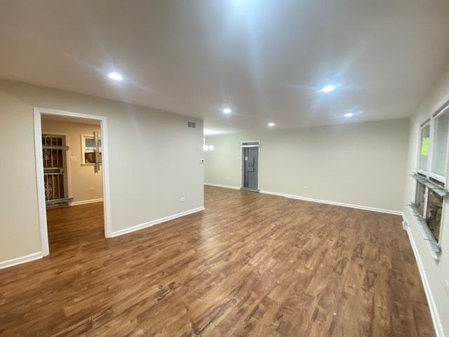 unfurnished living room with dark hardwood / wood-style floors