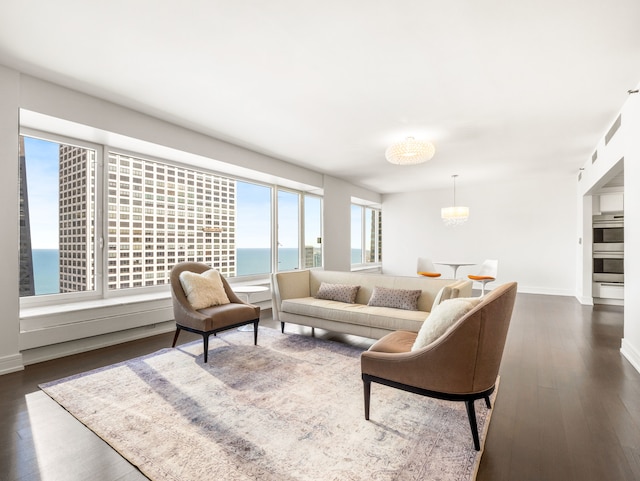 living room featuring a water view and dark hardwood / wood-style floors