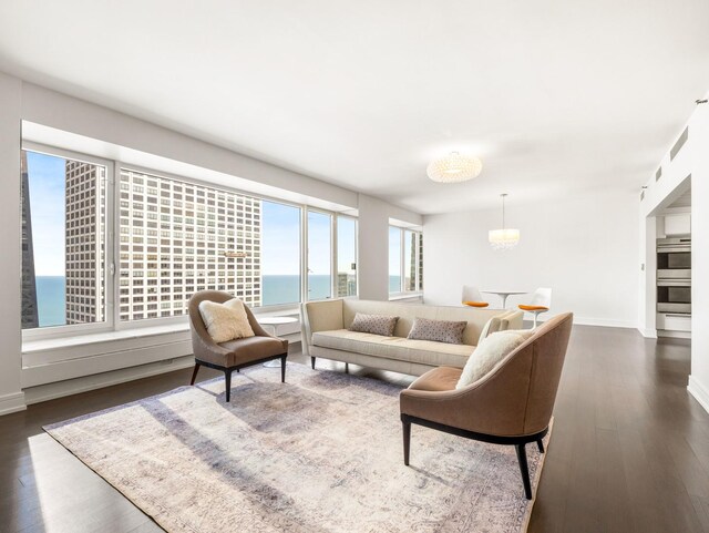 161 E Chicago Ave Unit 42H, Chicago, IL 60611 - living area with dark wood-style floors, a chandelier, and a water view