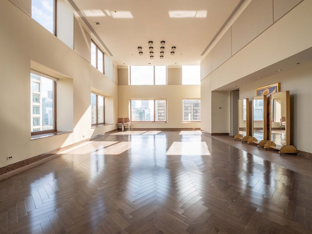 interior space with parquet flooring and a high ceiling