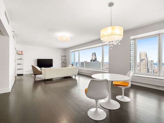 bedroom with dark hardwood / wood-style flooring and an inviting chandelier