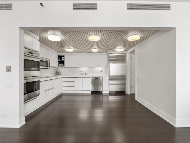 161 E Chicago Ave Unit 42H, Chicago, IL 60611 - kitchen featuring appliances with stainless steel finishes, light countertops, white cabinets, open shelves, and dark wood-style floors