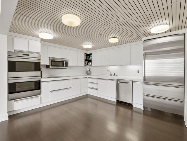161 E Chicago Ave Unit 42H, Chicago, IL 60611 - kitchen featuring appliances with stainless steel finishes, open shelves, light countertops, and white cabinetry