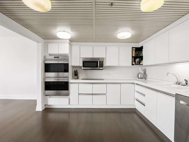 161 E Chicago Ave Unit 42H, Chicago, IL 60611 - kitchen with stainless steel appliances, white cabinets, light countertops, open shelves, and dark wood-type flooring