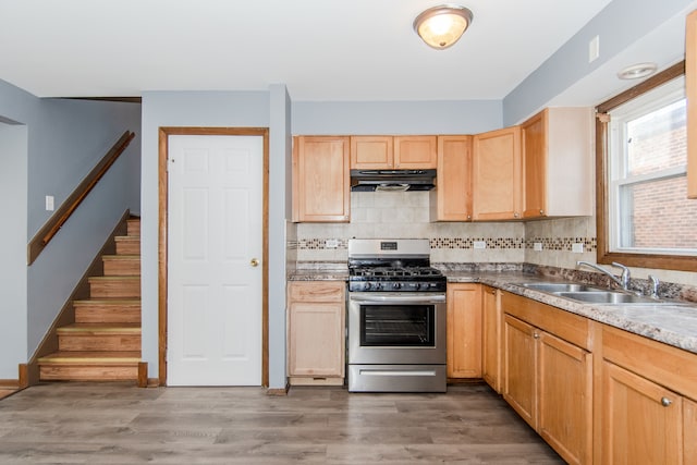 kitchen with hardwood / wood-style flooring, backsplash, sink, light brown cabinetry, and stainless steel range with gas stovetop