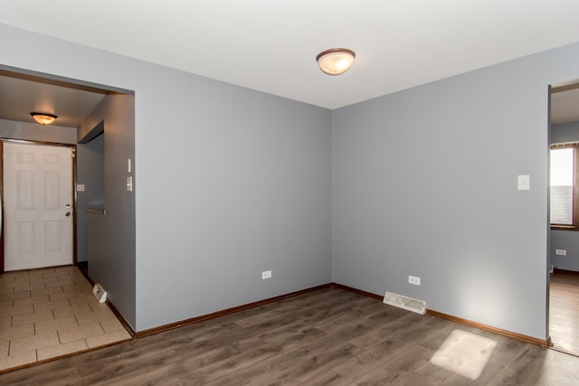 unfurnished room featuring hardwood / wood-style floors