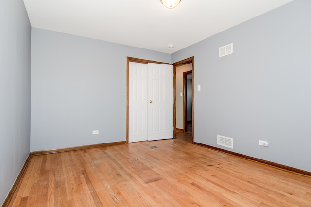 empty room with light hardwood / wood-style flooring